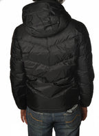 Modello indossa piumino corto trapuntato nero Woolrich con cappuccio