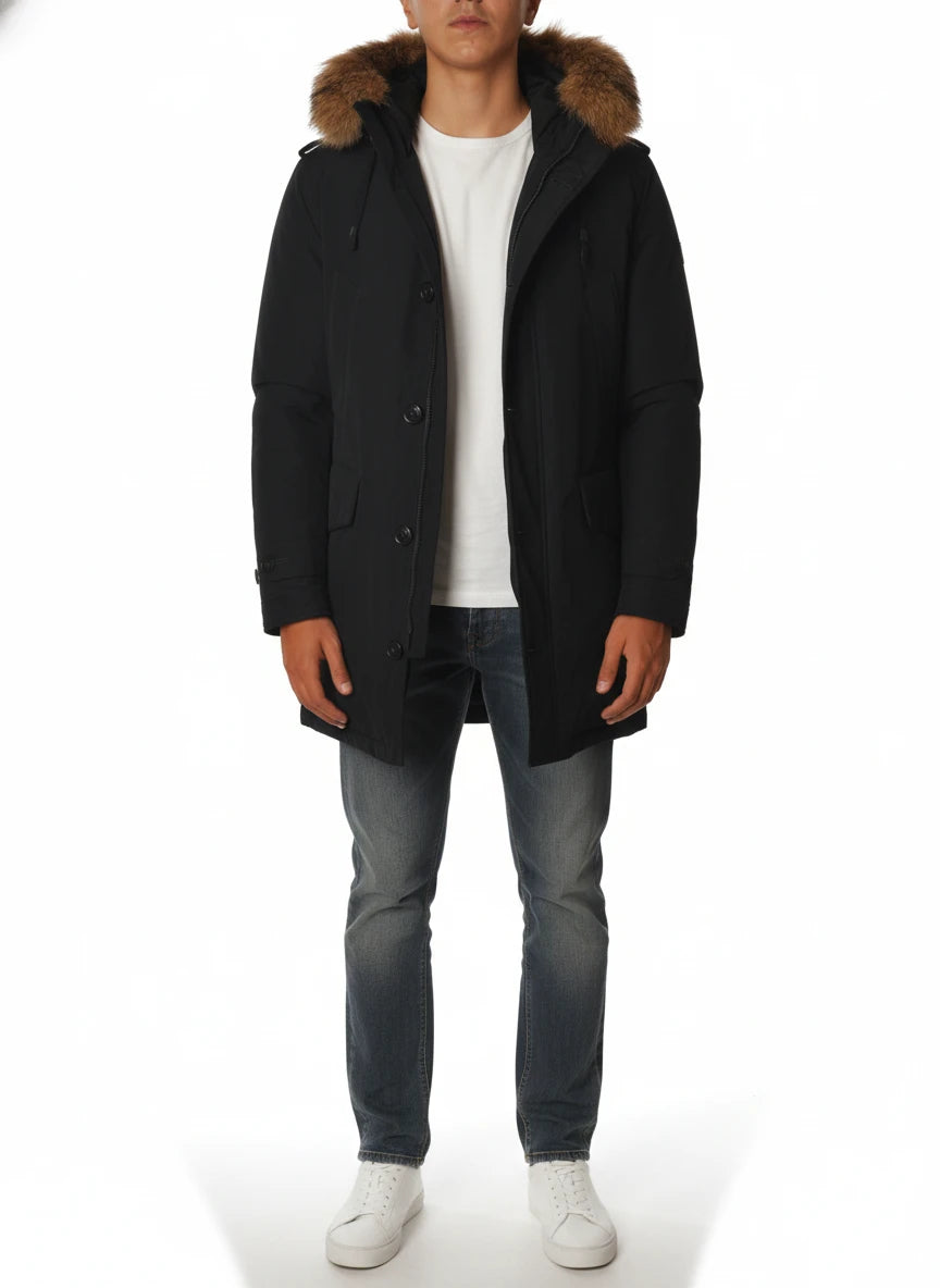 Modello indossa parka blu con cappuccio, pelliccia e toppe Woolrich