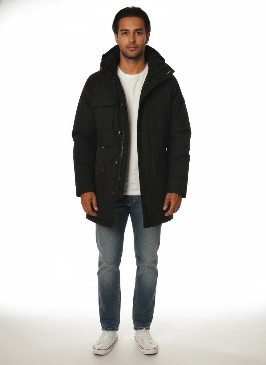 Modello indossa parka nero con cappuccio e tasca Woolrich in tessuto tecnico