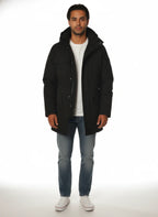 Modello indossa parka nero con cappuccio e tasca Woolrich in tessuto tecnico