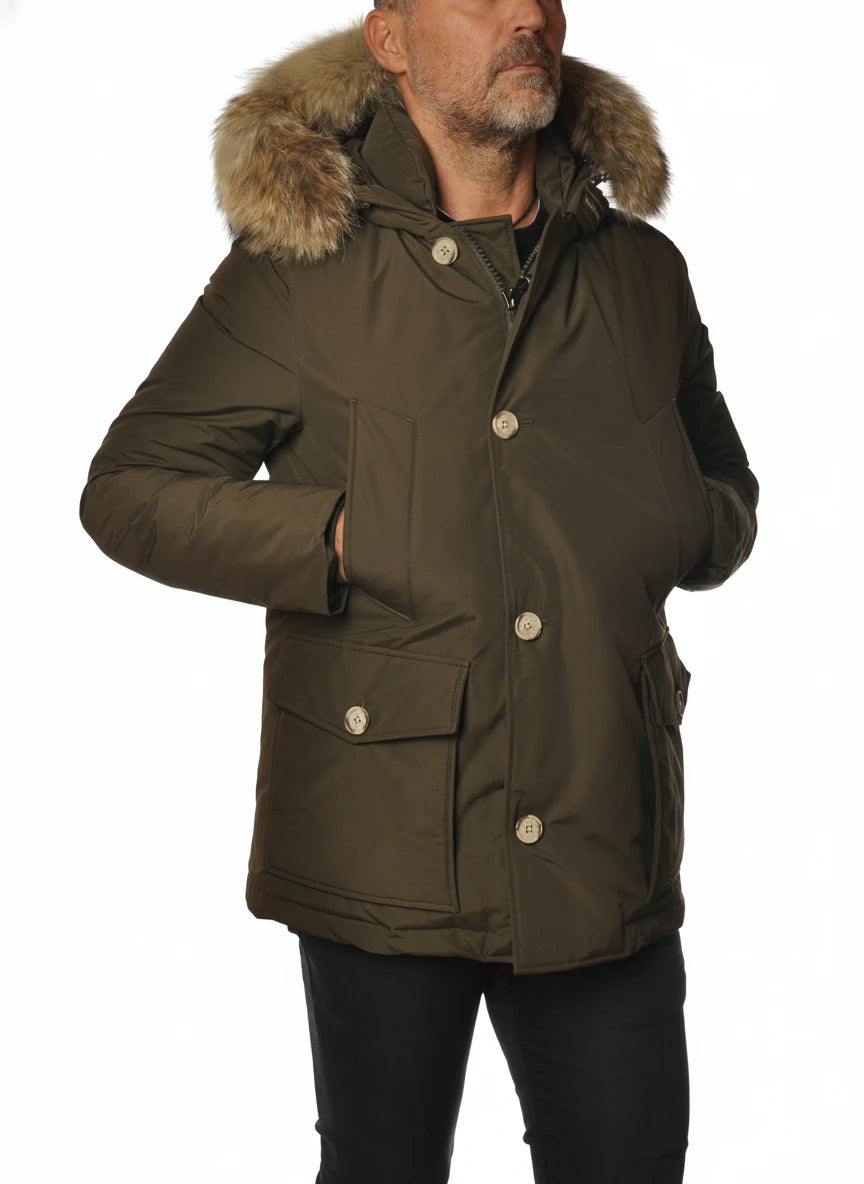Modello indossa anorak verde con cappuccio e pelliccia Woolrich