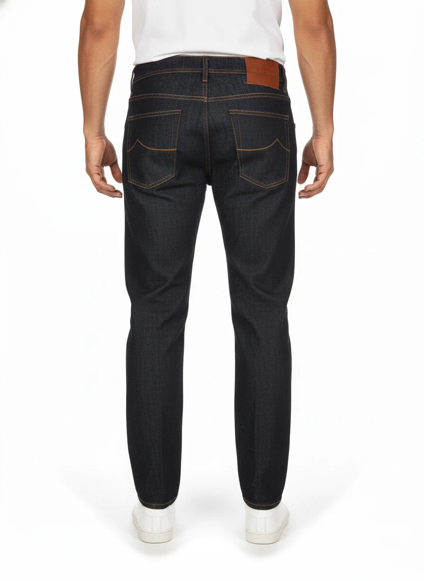 Back view of model wearing jeans narrow leg wash blue scur Jacob Cohen