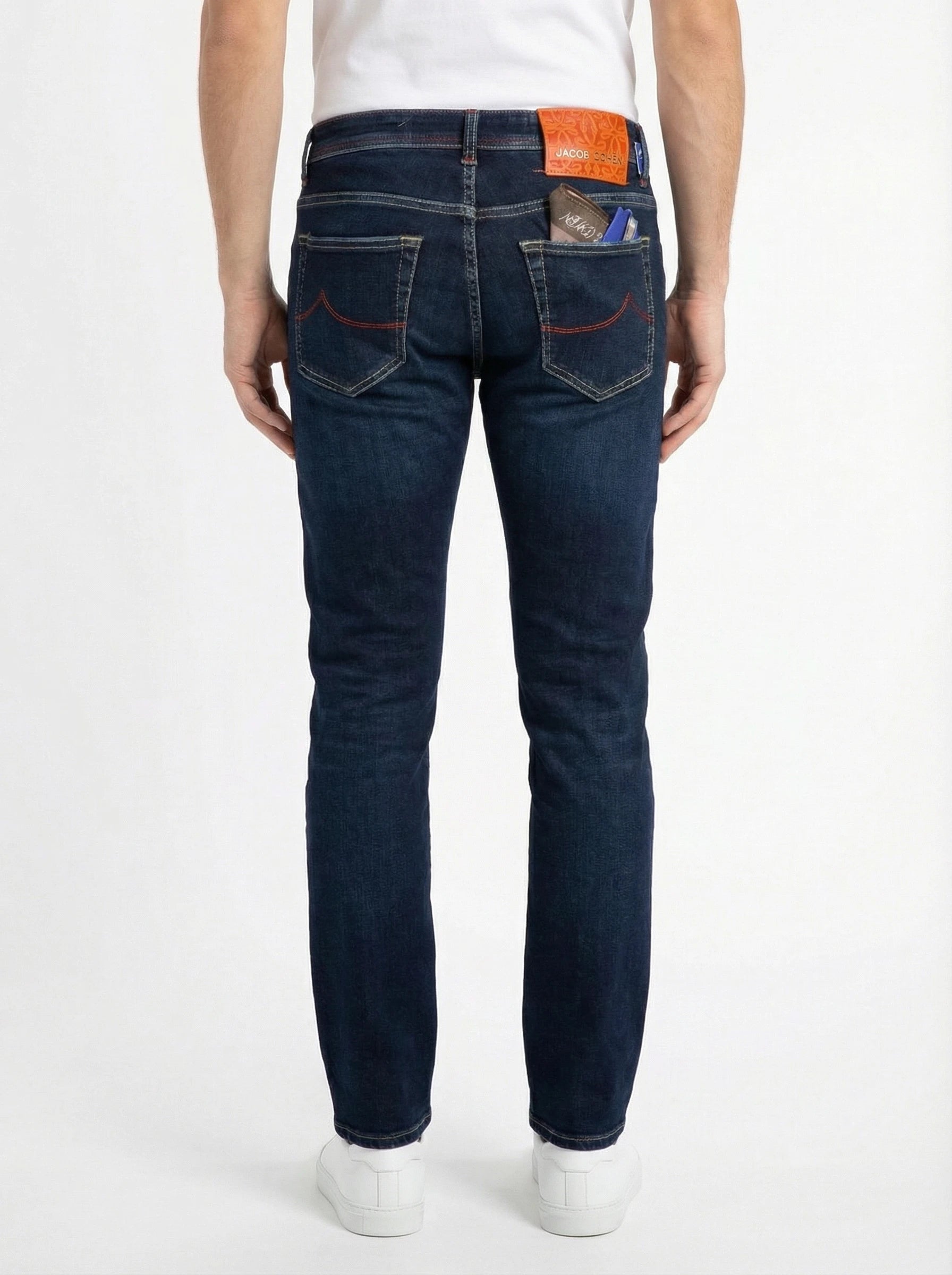 Back view of model wearing slim‑fit jeans dark wash Jacob Cohen denim