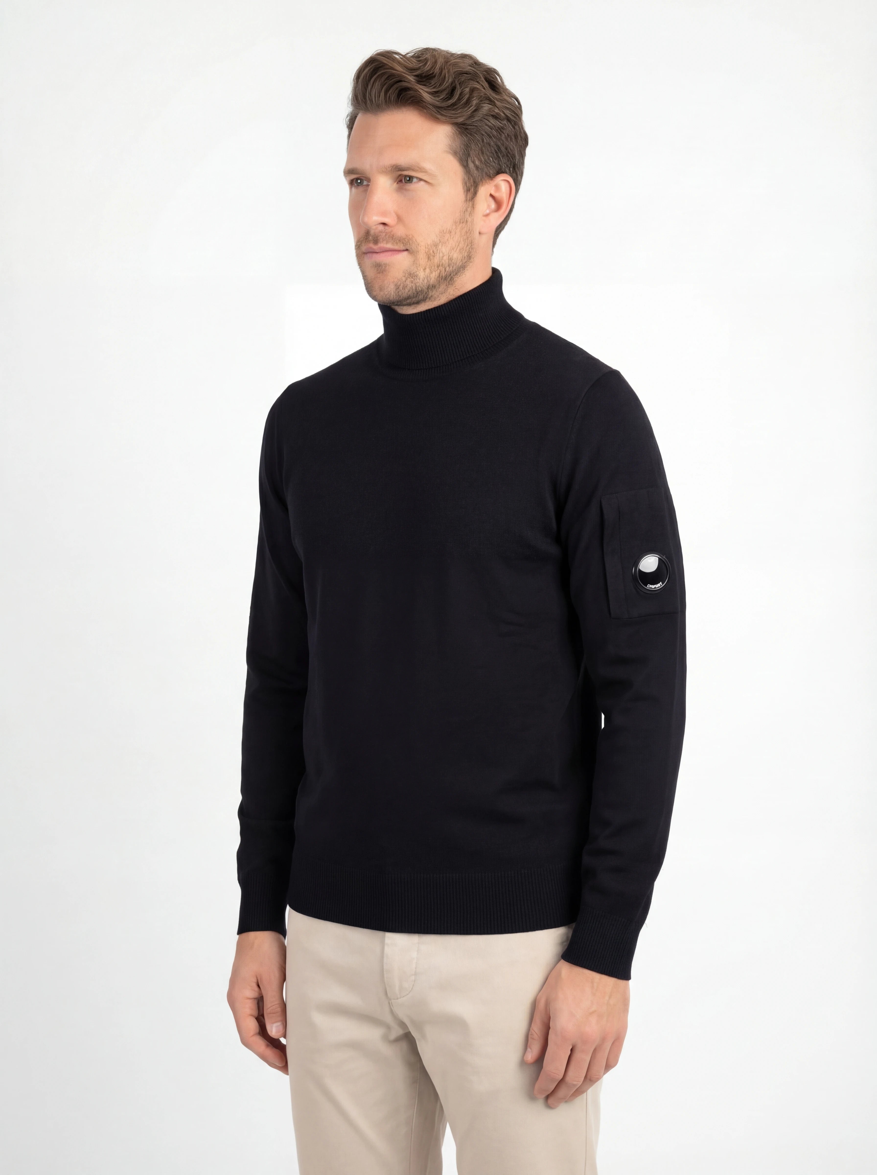 Modello indossa maglia collo alto blu zip taschino C.P. Company da uomo