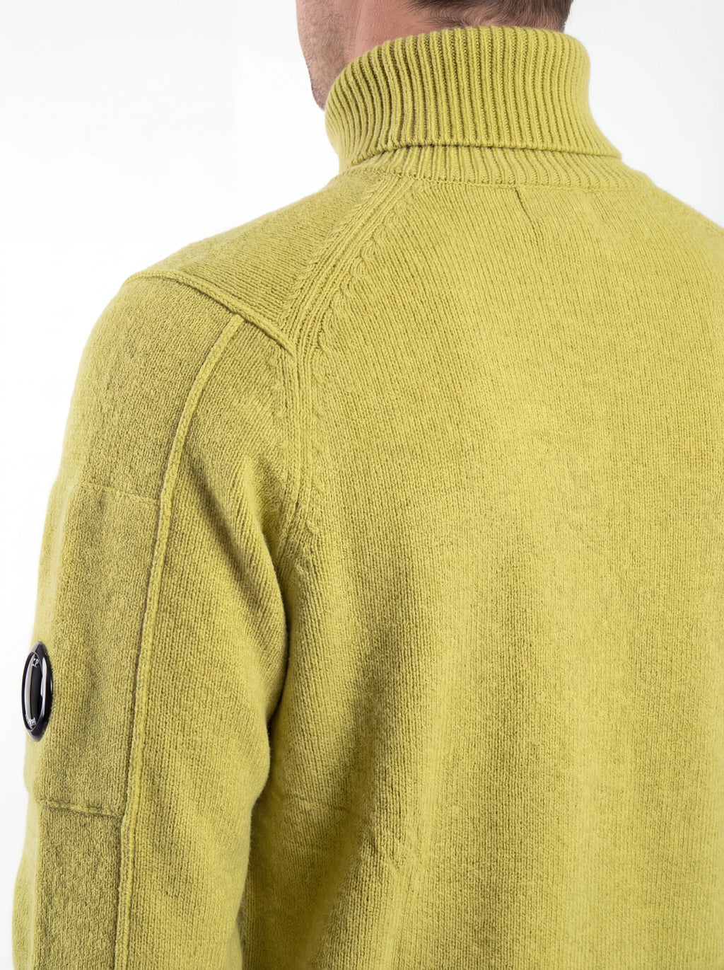 Vista da dietro, modello con maglia collo alto cedro spalla raglan manica a rilievo C.P. Company da uomo