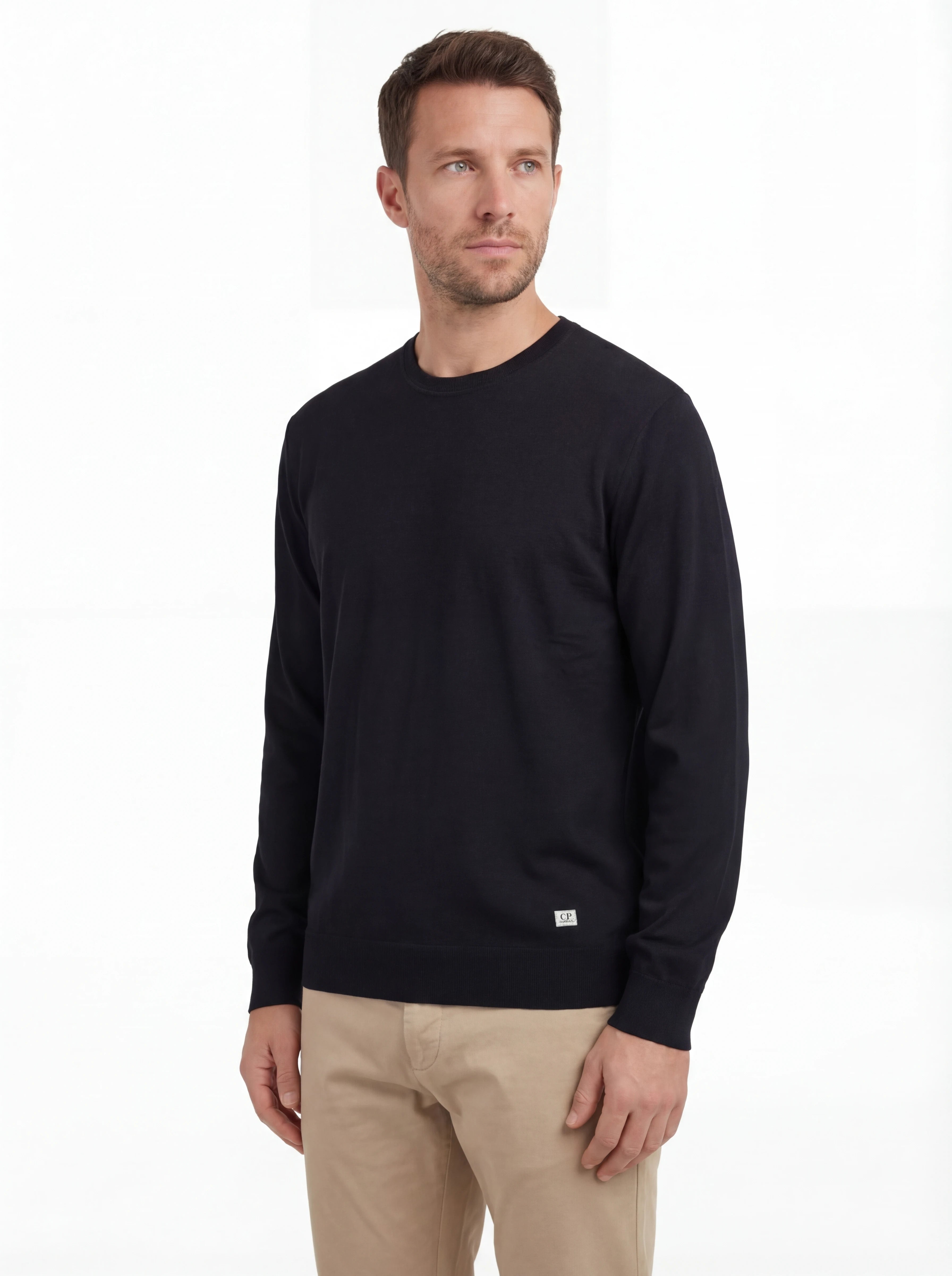 Modello indossa maglia girocollo blu logo cucito vestibilità dritta C.P. Company da uomo