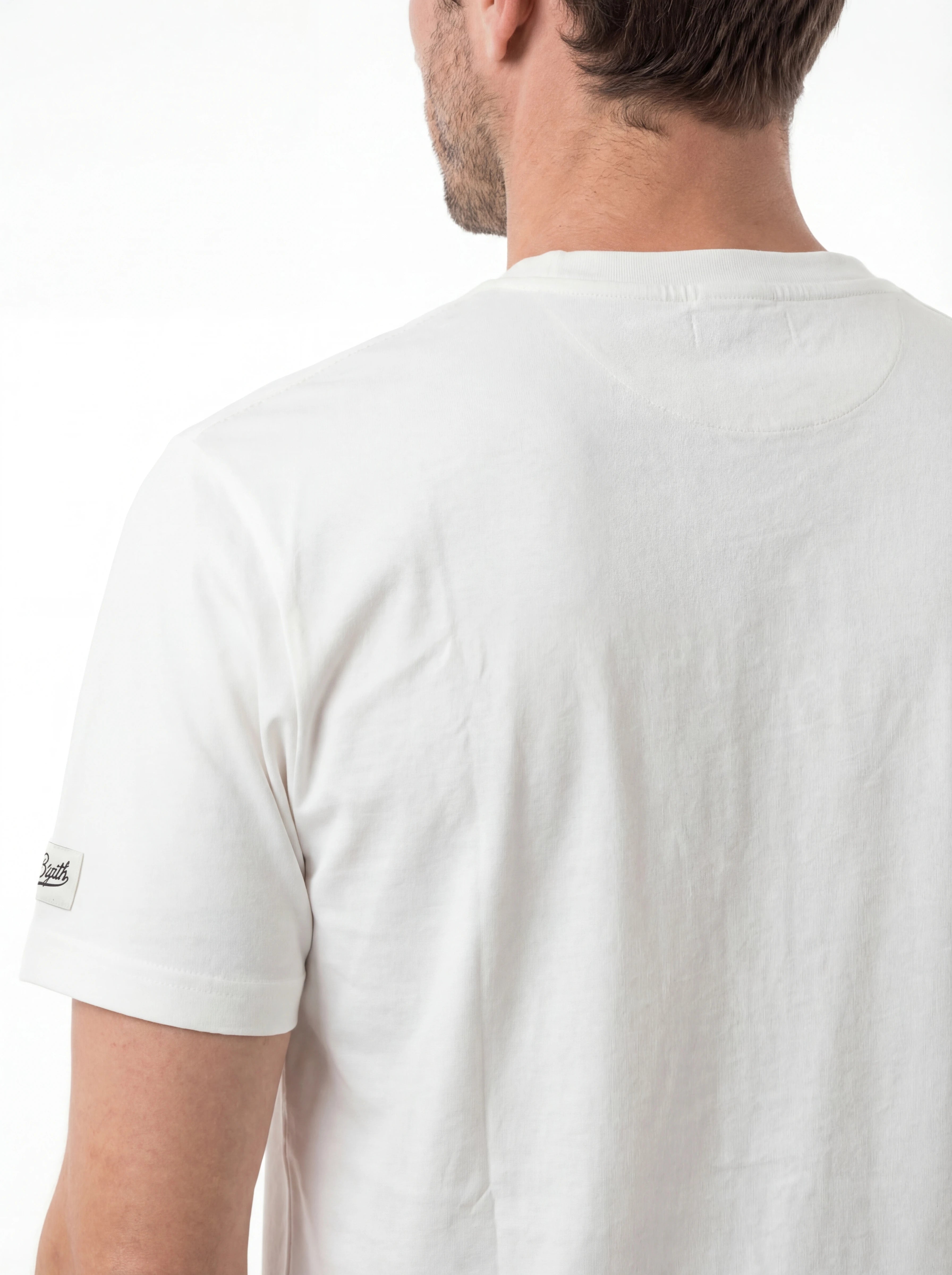 T-shirt su sfondo neutro da dietro t-shirt bianco scritta “APRÈS PADEL” Saint Barth cotone